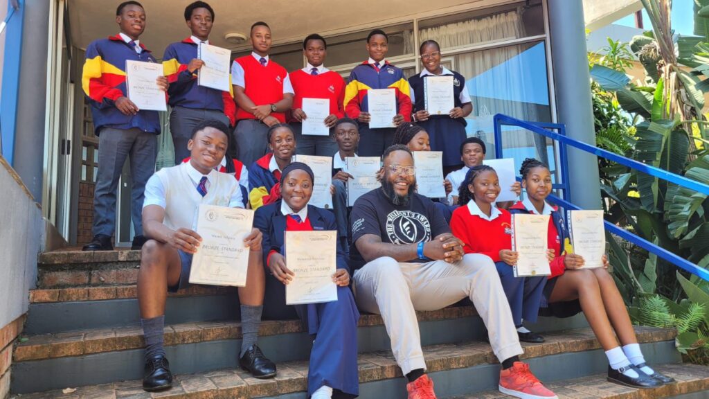 Youth participants receiving their President's Award certificates at school.